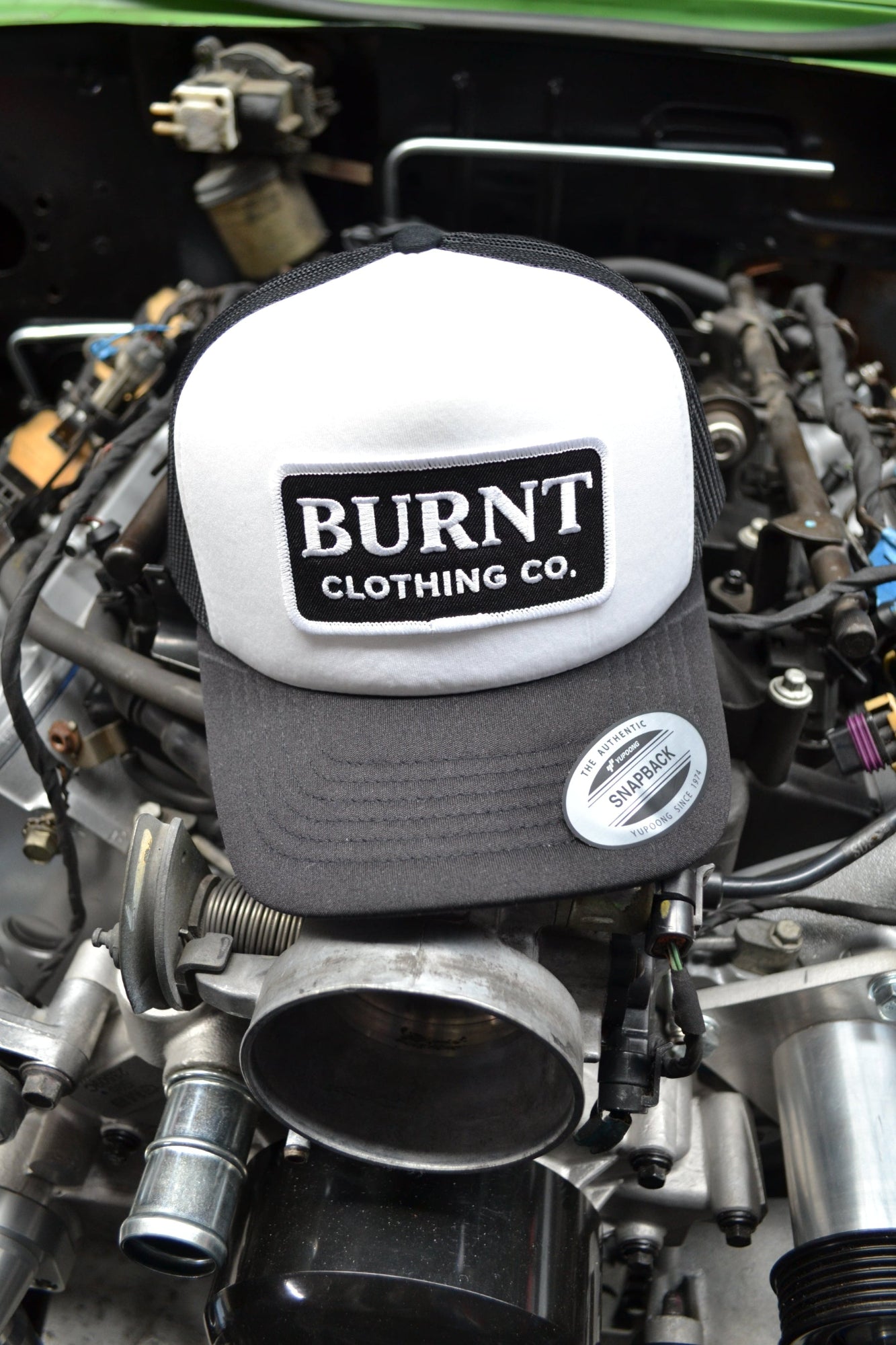 Engine with a 'Burnt Clothing Co.' cover and visible branding.