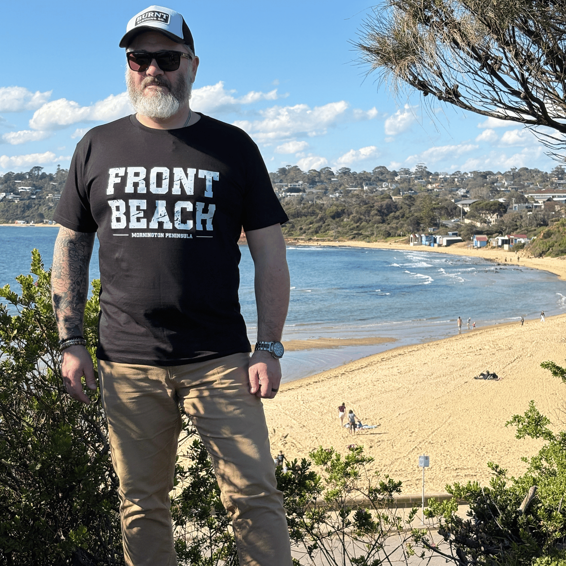 Full-length view of the Front Beach black tee overlooking the Mornington Peninsula coastline