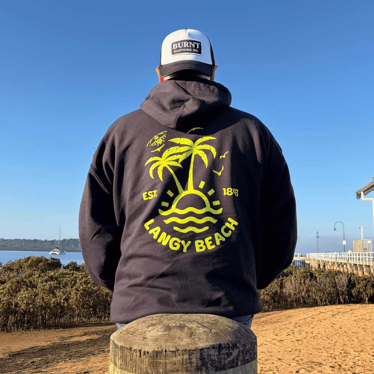Model wearing black Langy Beach hoodie by Burnt Clothing Co