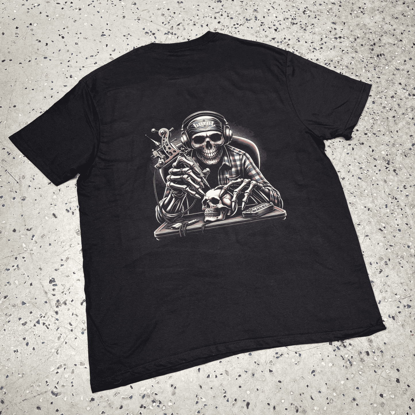Black Last Session tee by Burnt Clothing Co laid flat, showing full back skull tattoo artist graphic