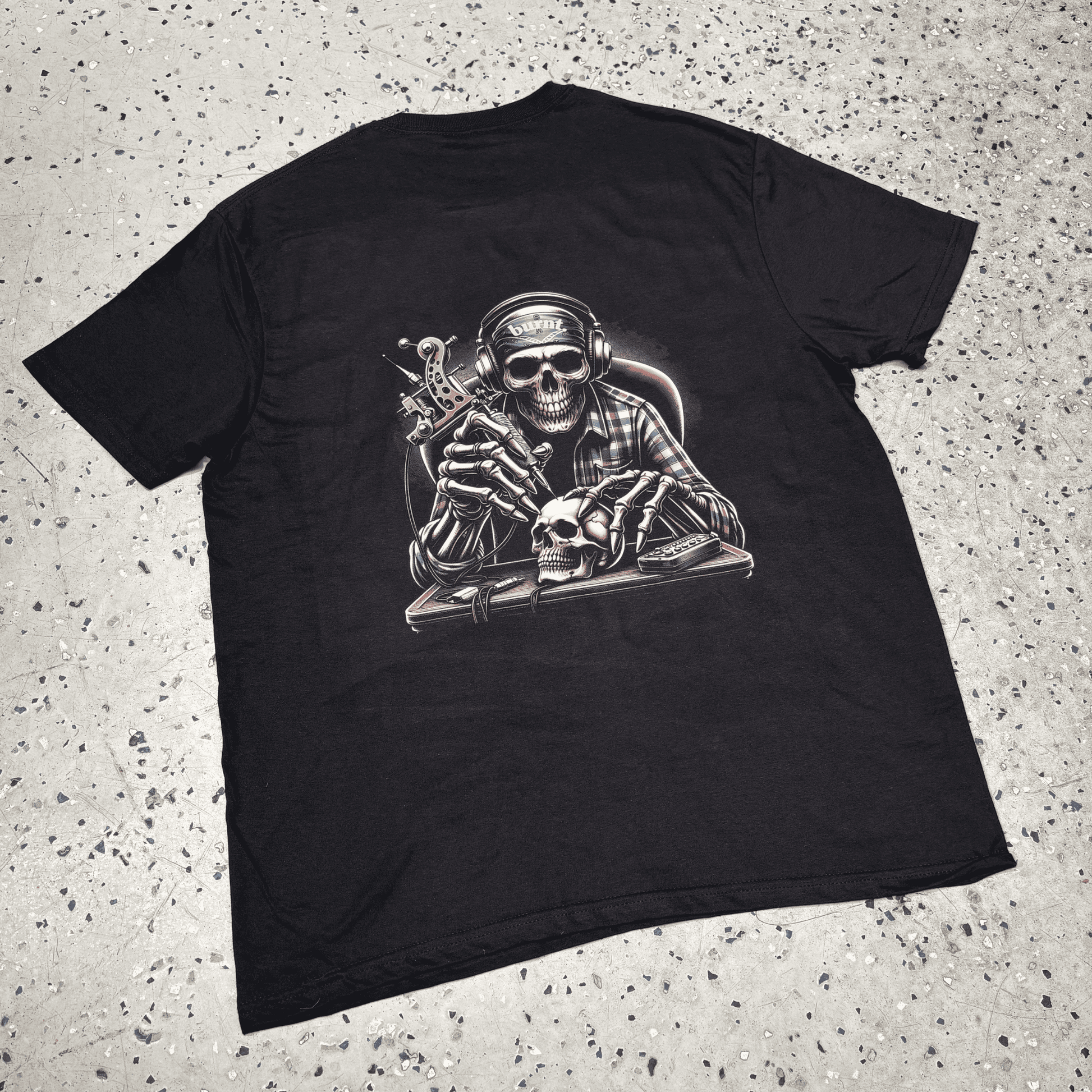 Black Last Session tee by Burnt Clothing Co laid flat, showing full back skull tattoo artist graphic