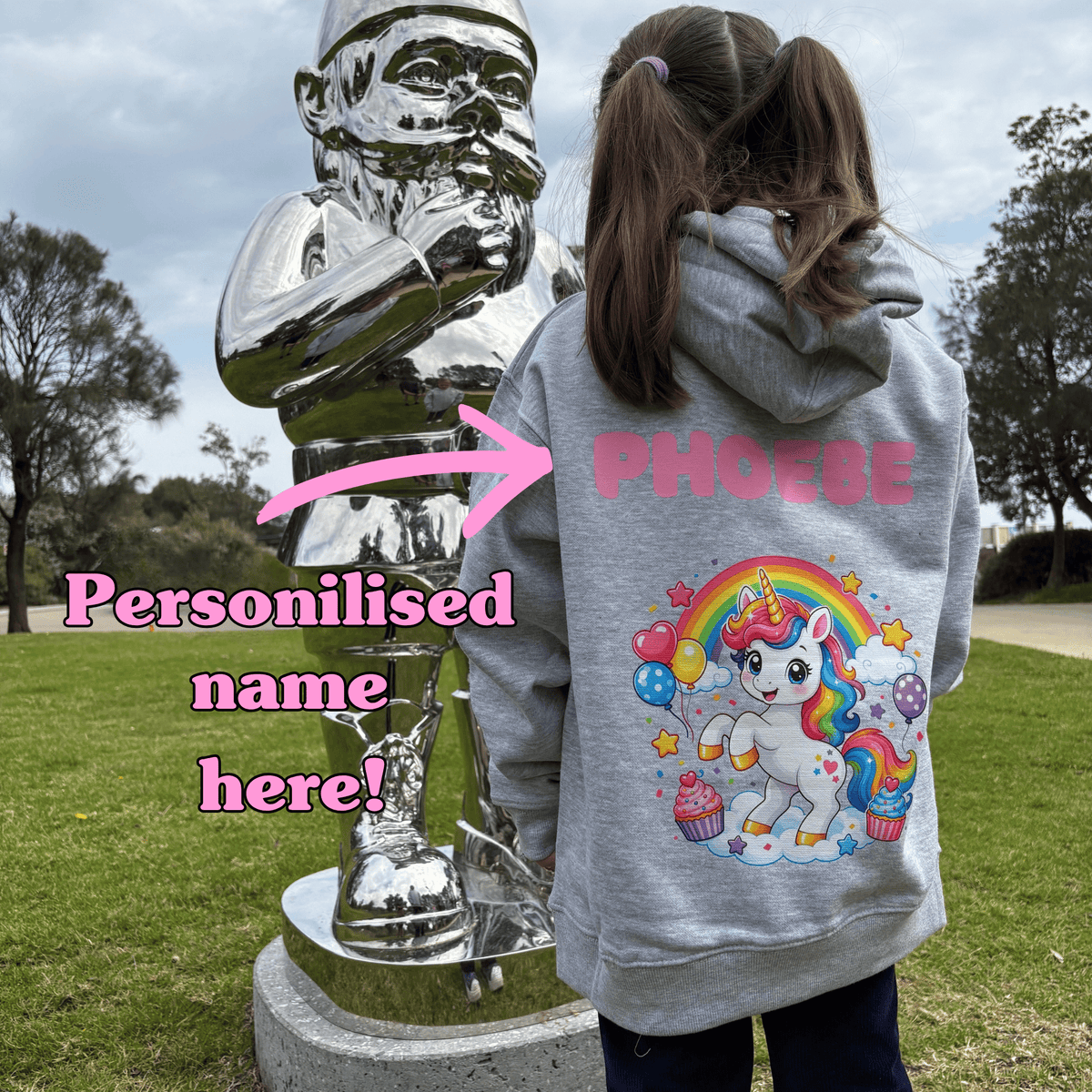 Child wearing grey Cupcake Unicorn kids hoodie showing personalised name placement