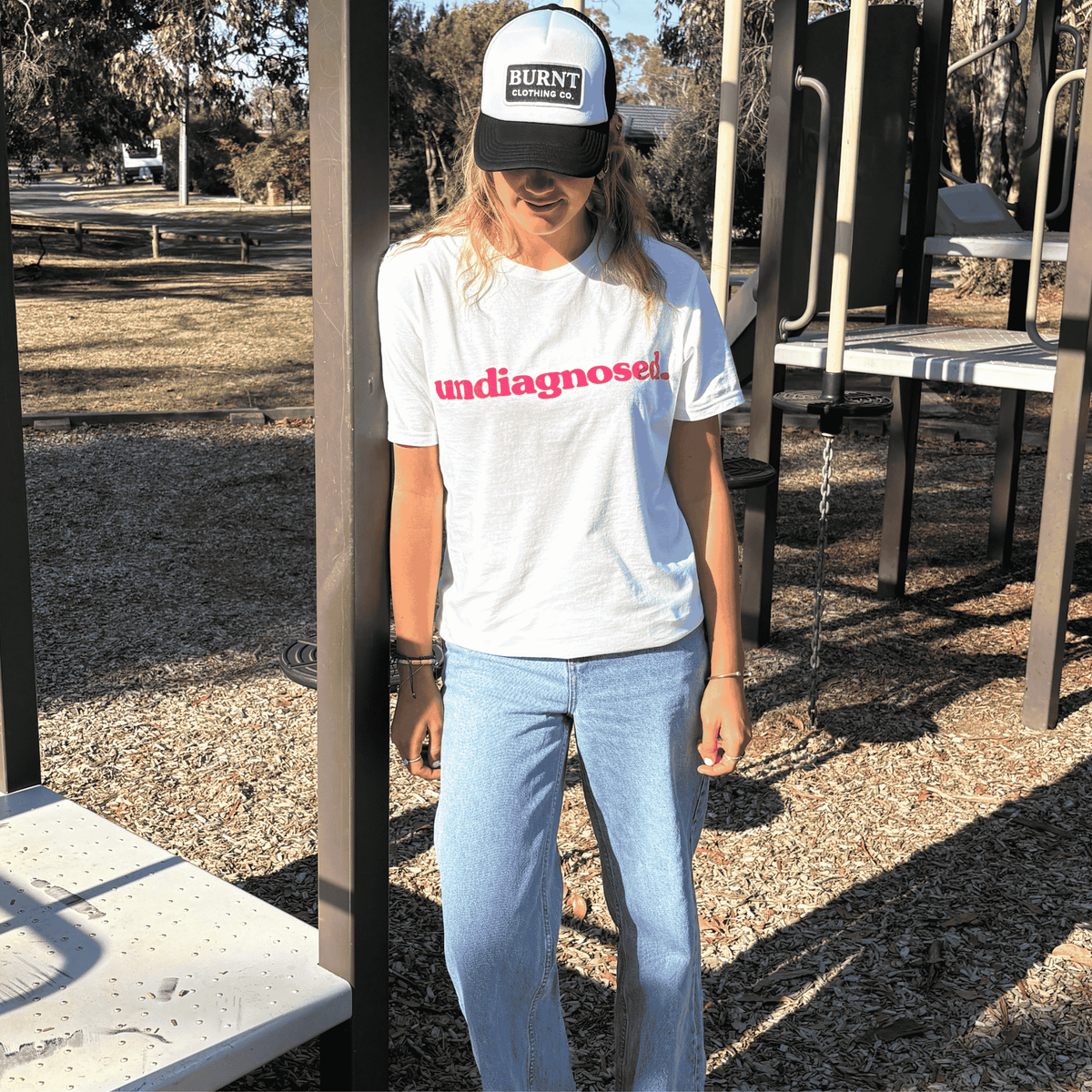 White undiagnosed. t-shirt with pink statement print by Burnt Clothing Co.