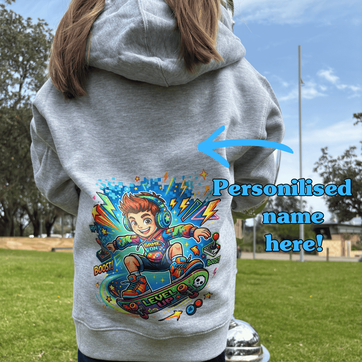 Child wearing grey Pixel Skater kids hoodie showing personalised name placement