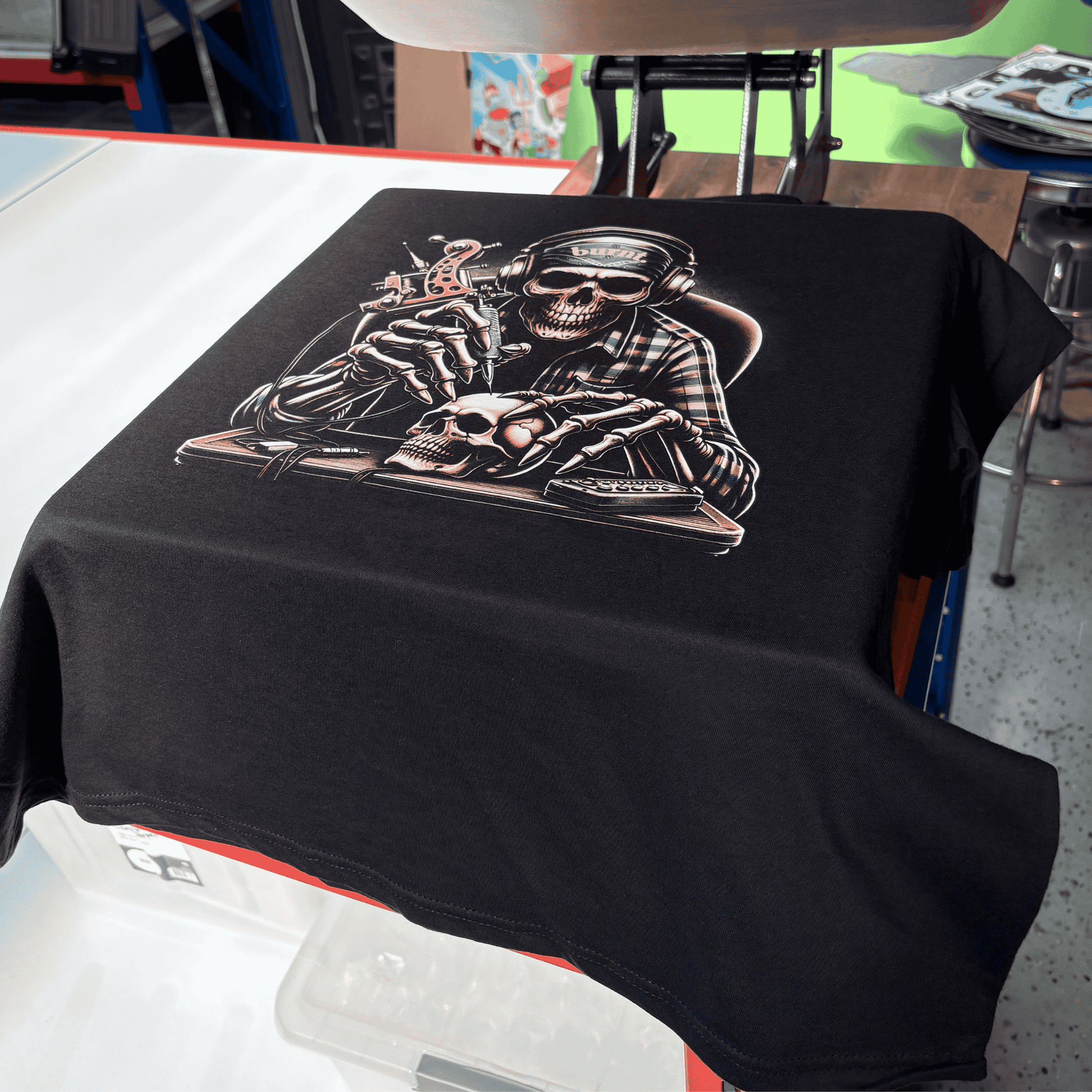 Close-up of Last Session tee print showing detailed skull tattoo artist graphic on black fabric