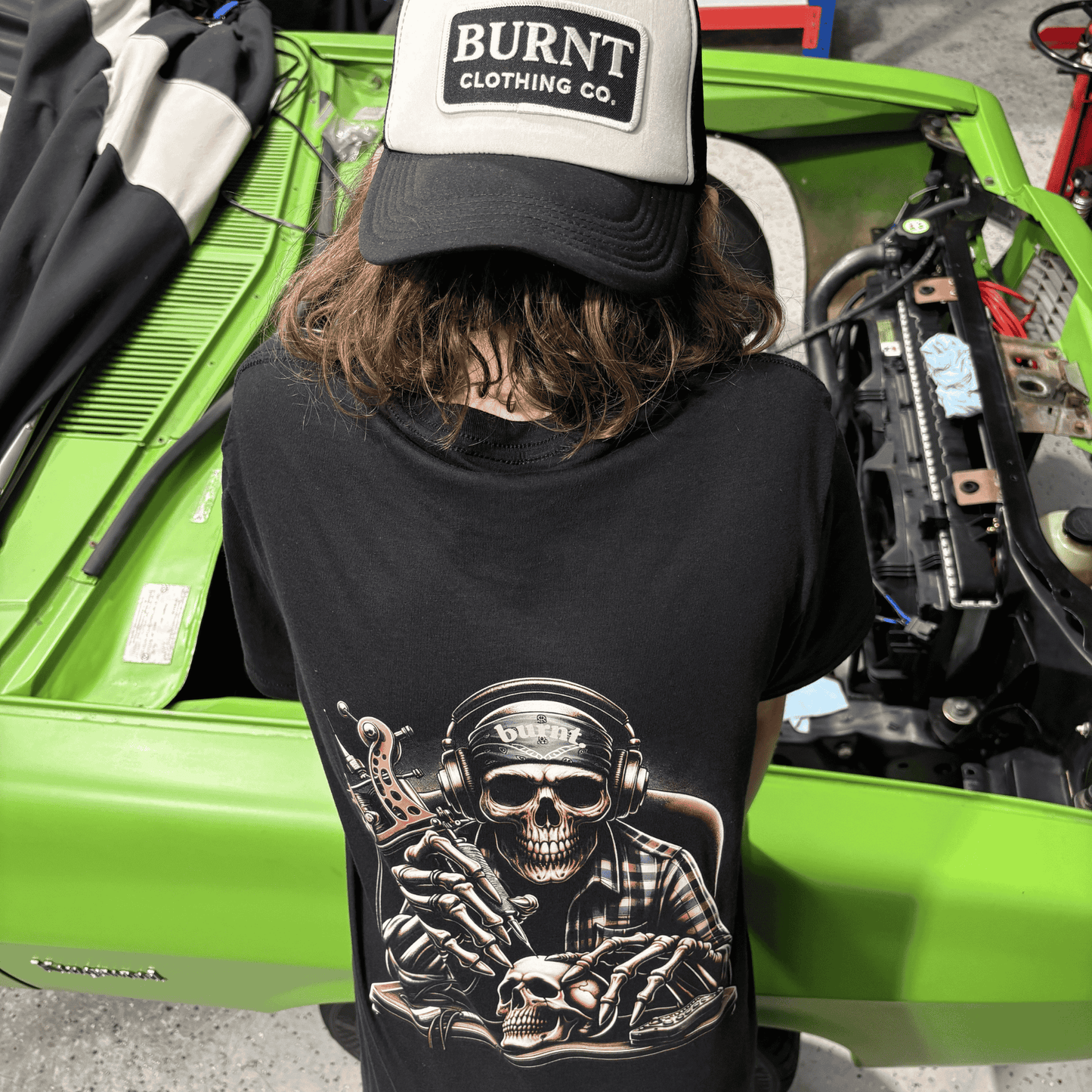 Burnt Clothing Co Last Session tee worn outdoors with skull tattoo artist back graphic