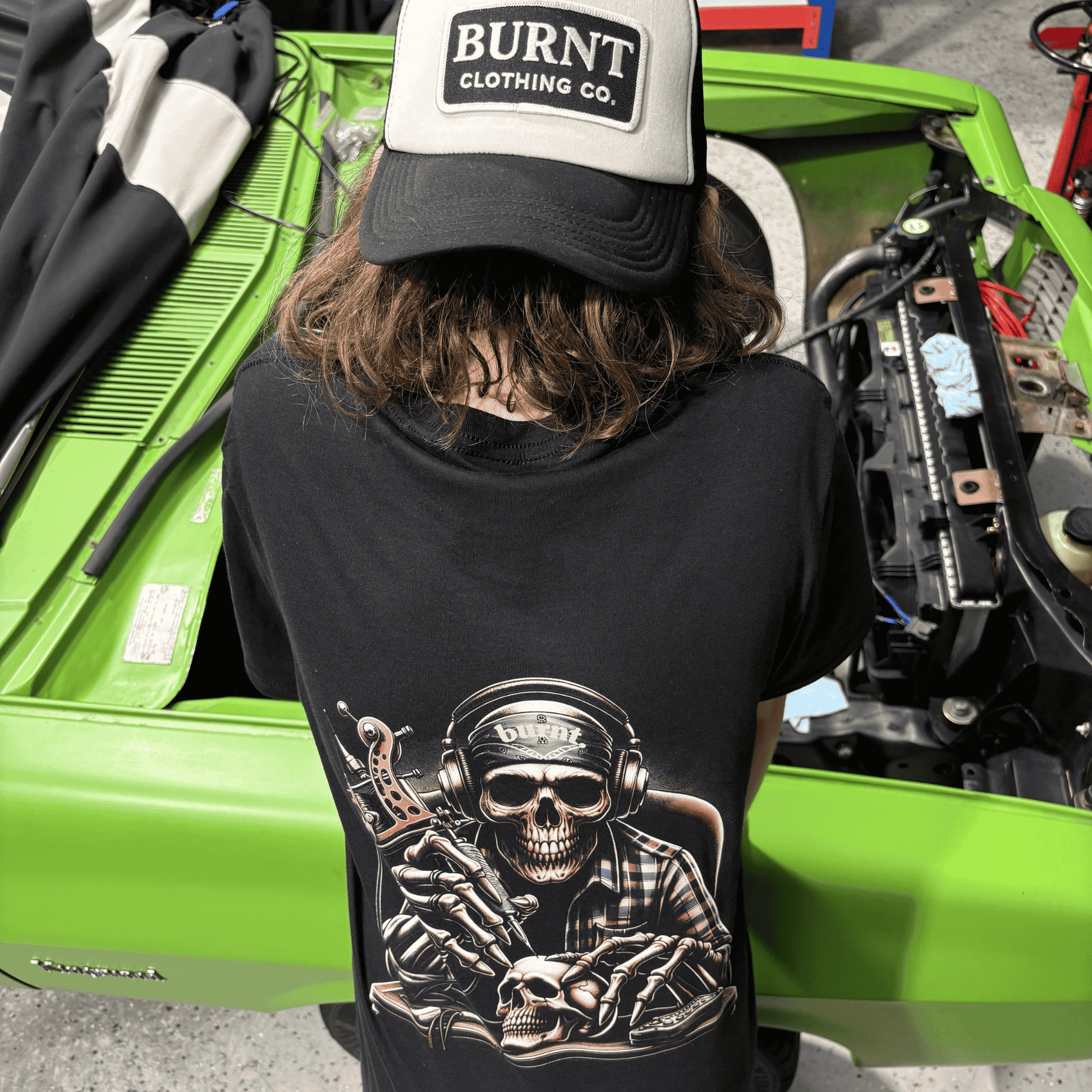 Burnt Clothing Co Last Session tee worn outdoors with skull tattoo artist back graphic