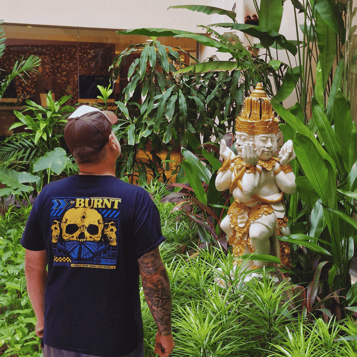 Model wearing Skull Speak graphic T-shirt by Burnt Clothing Co.