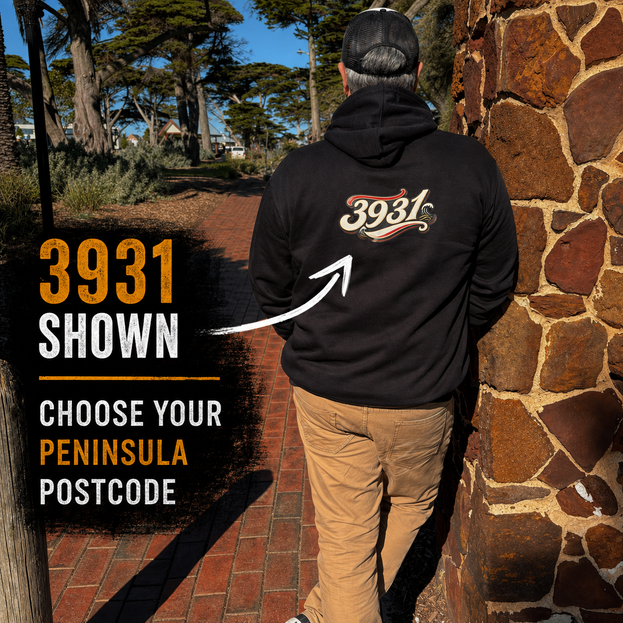 Rear view of The Ninch black hoodie showing example 3931 postcode and choose your Peninsula postcode message