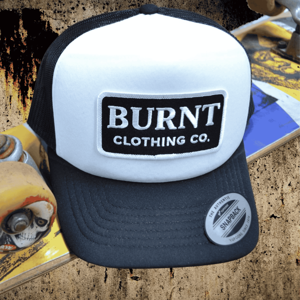 Burnt YP Snapback black and white trucker cap.