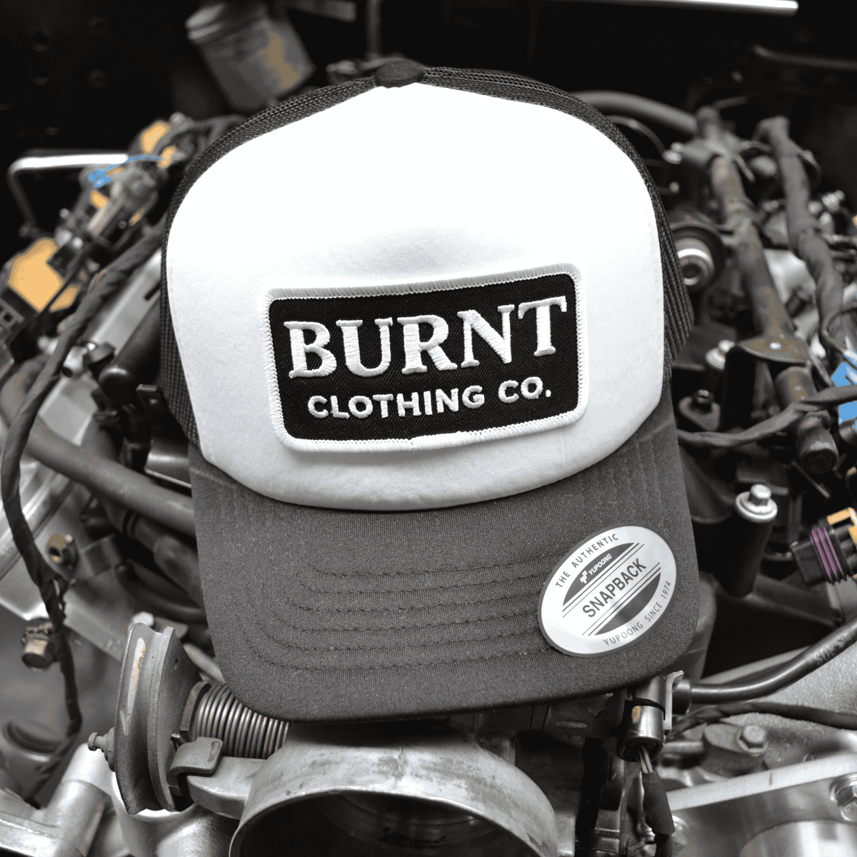 Burnt YP Snapback trucker cap product view.