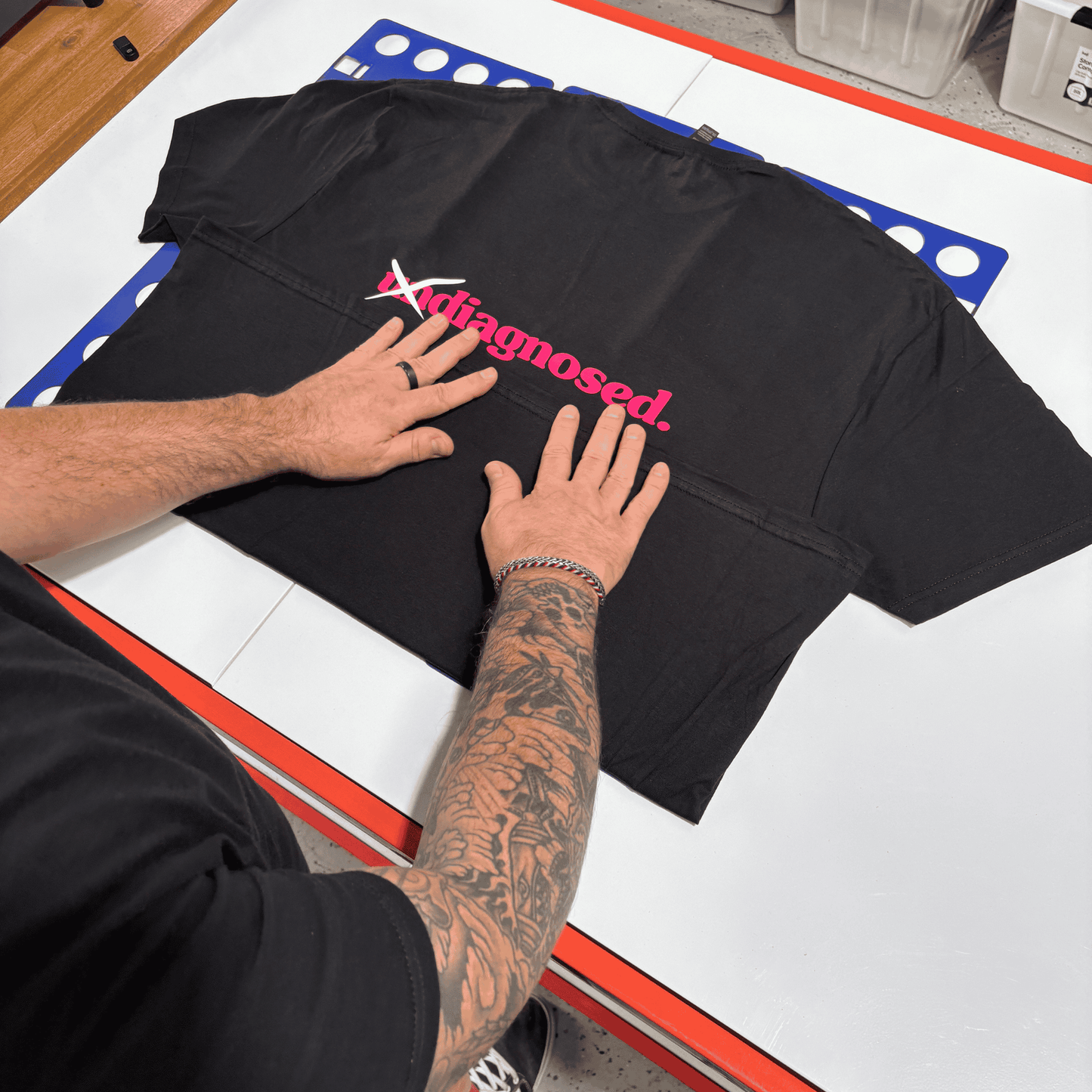 Hand-pressed diagnosed. black t-shirt during production