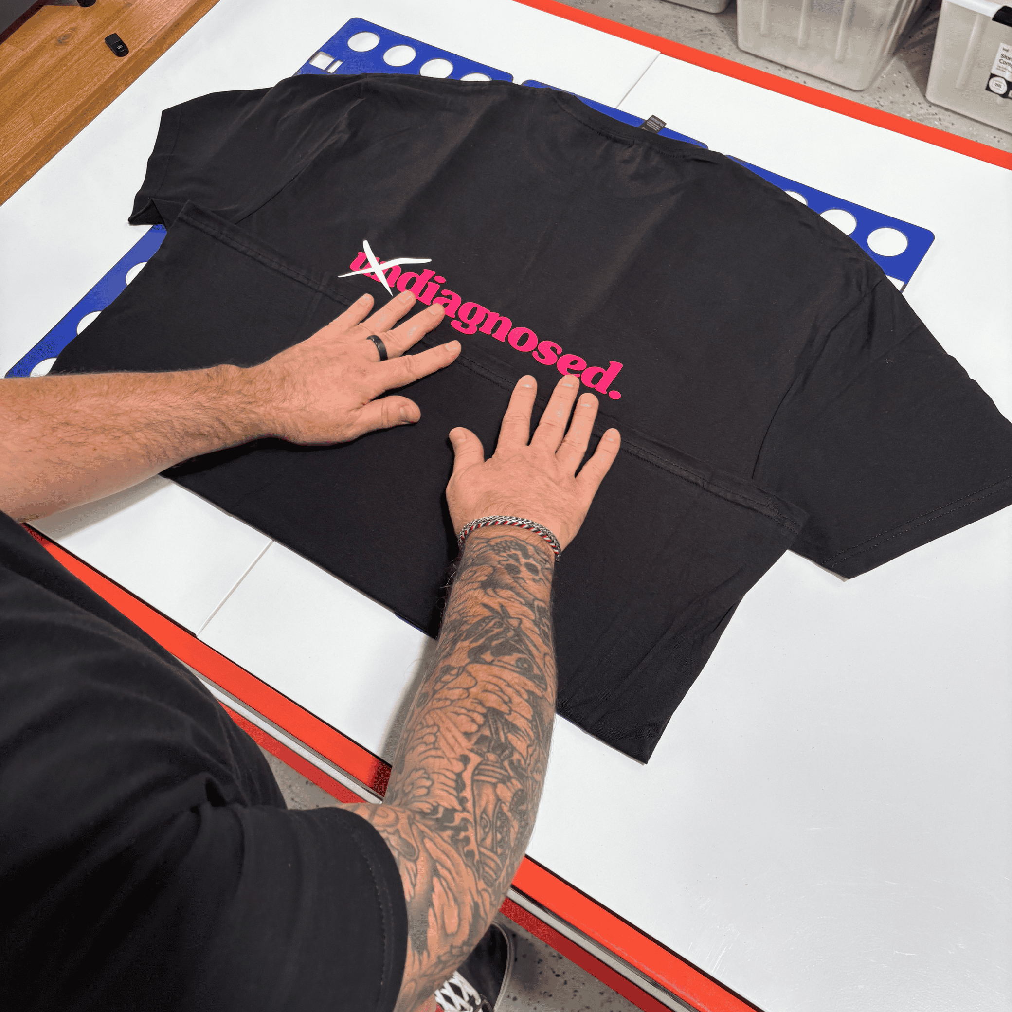Hand-pressed diagnosed. black t-shirt during production