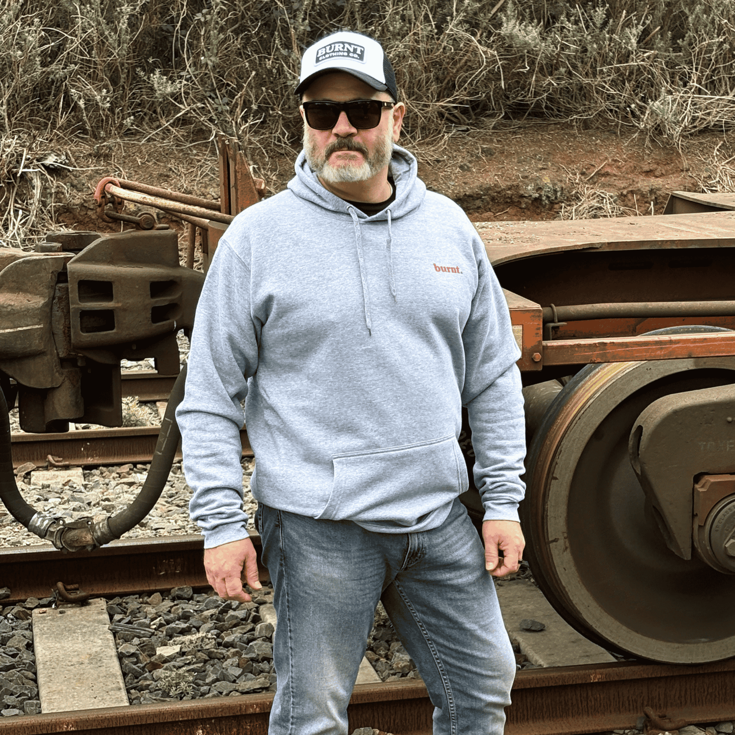 Model wearing diagnosed. grey hoodie by Burnt Clothing Co outdoors