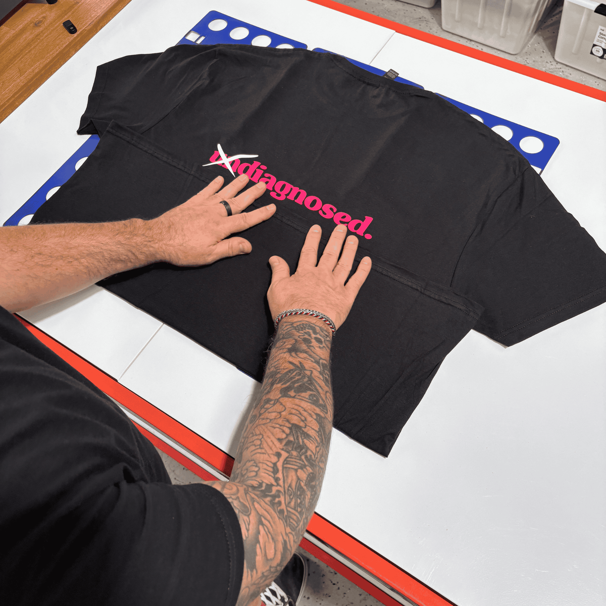 Hand-pressed diagnosed. black t-shirt during production