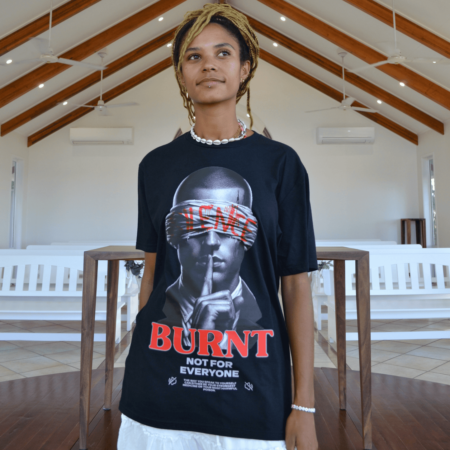 The Quiet War black graphic tee worn by model indoors