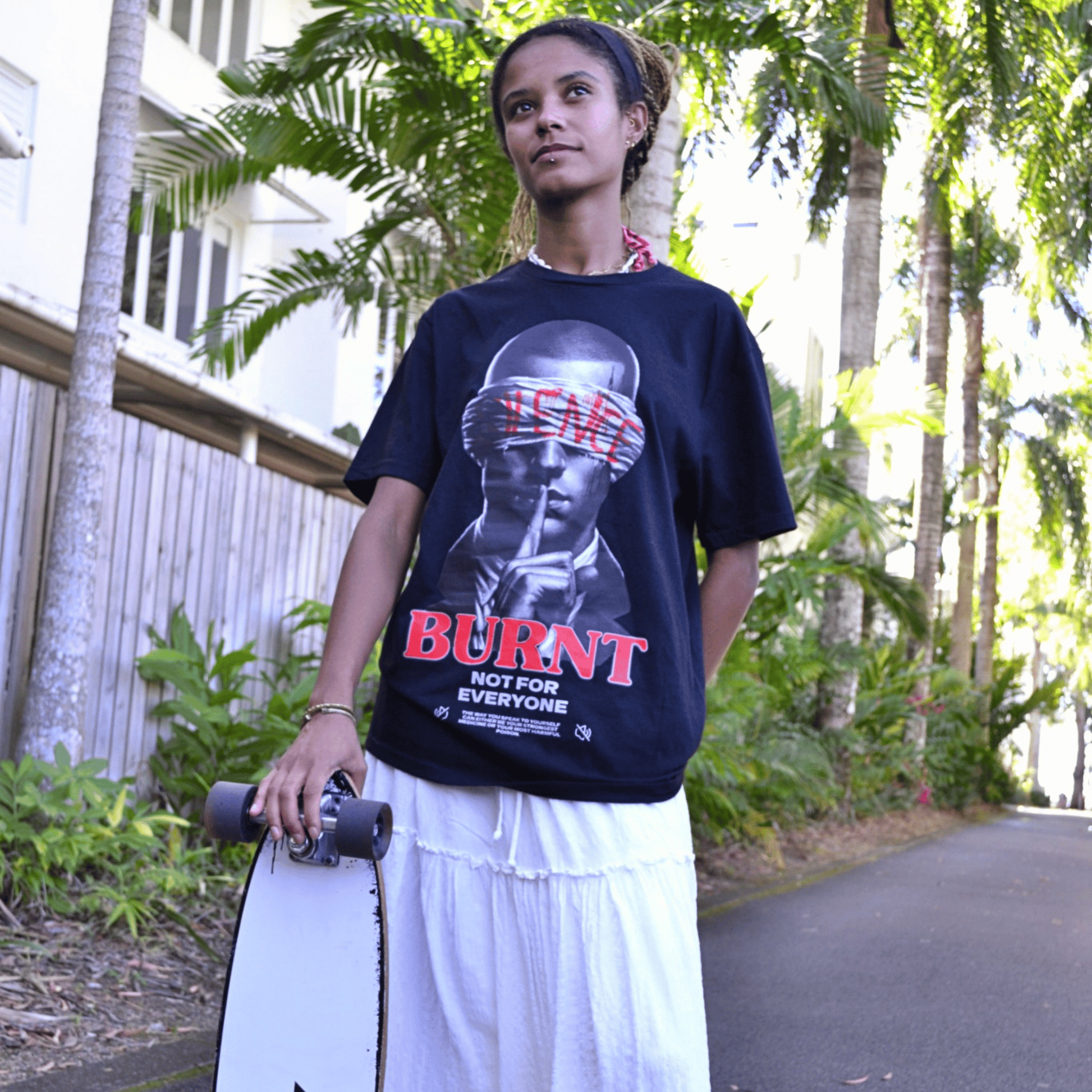 Model wearing The Quiet War black graphic tee by Burnt Clothing Co