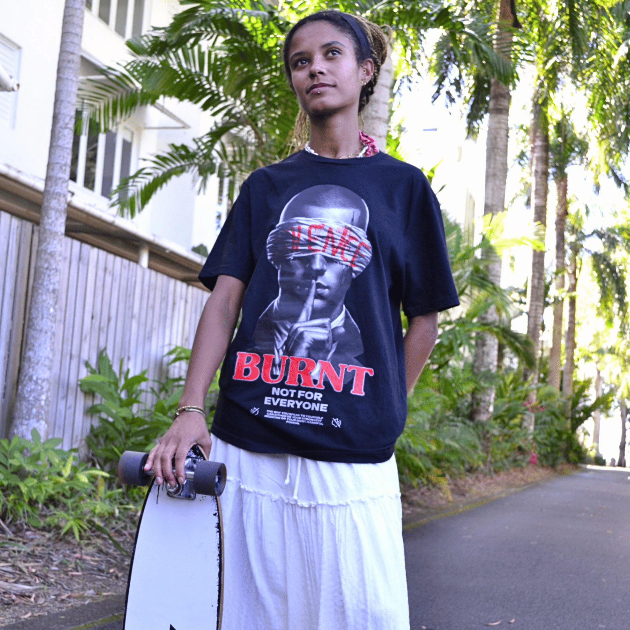 Model wearing The Quiet War black graphic tee by Burnt Clothing Co
