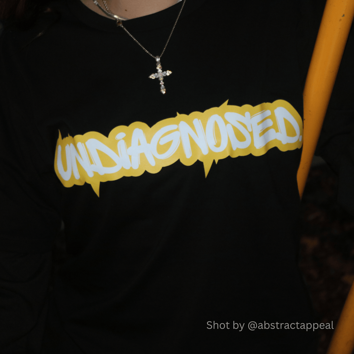 Close-up of the undiagnosed. graphic printed on a black tee