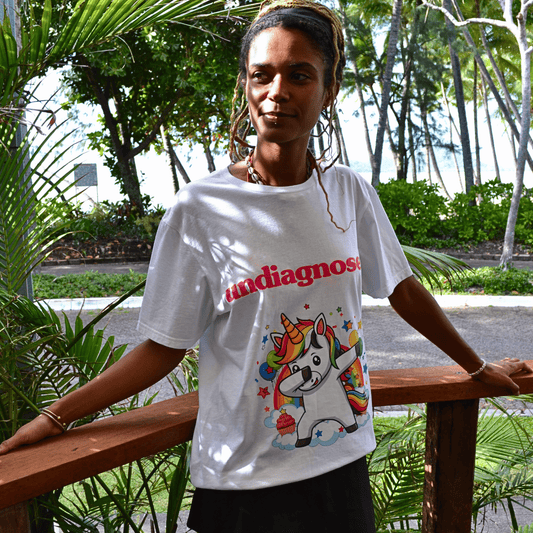 Model wearing undiagnosed. Unicorn white graphic tee by Burnt Clothing Co